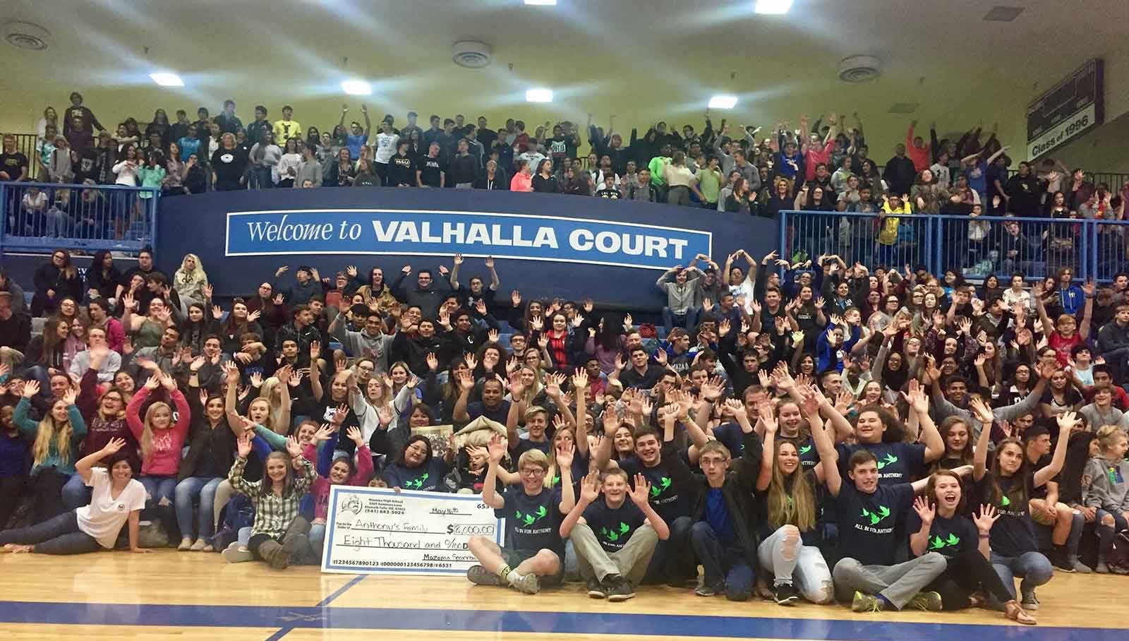 Valhalla school cheers in gym for over $8,000 raised for sparrow club.